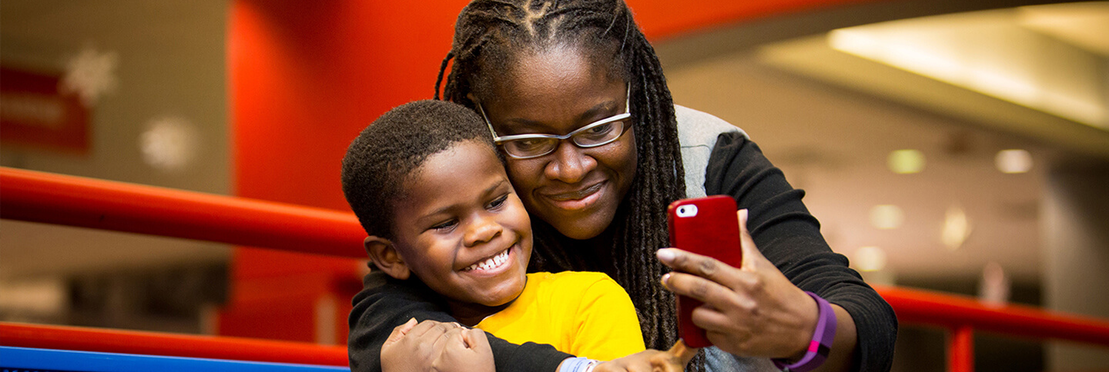 A woman and her son take a picture at the Science Center.