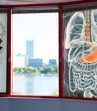 The cityscape of Pittsburgh seen through a window at the Kamin Science Center.