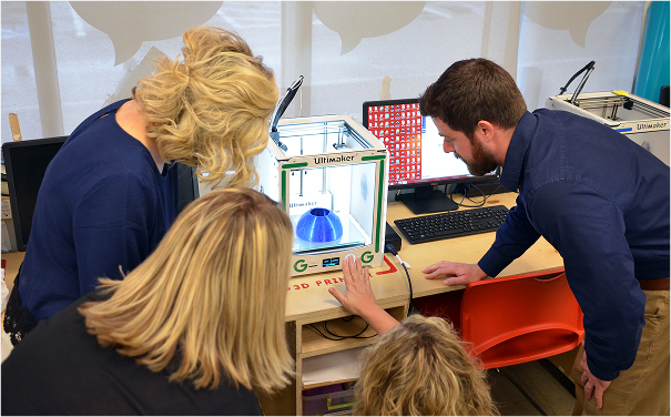 Group of adults creating a 3D object in BNY Fab Lab.