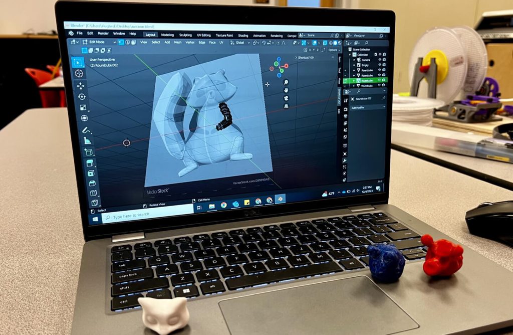 A laptop with a three-dimensional raccoon.